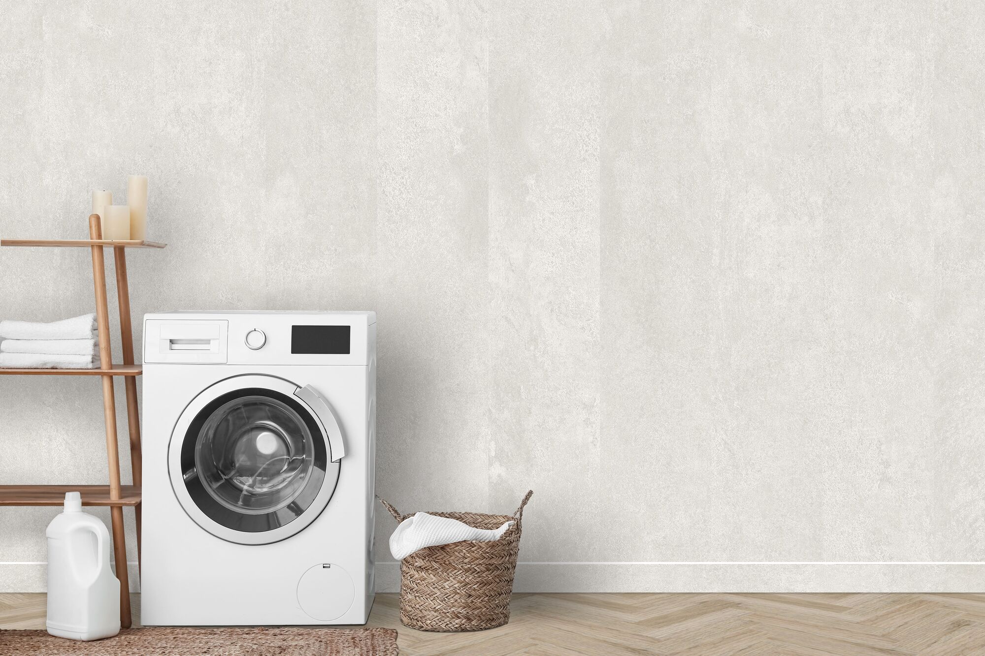 Washing machine standing in front of a beige wall
